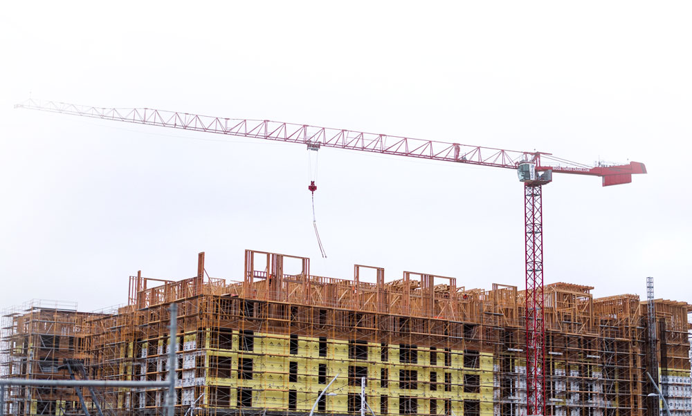 High-rise concrete frame under construction with tower crane, typical of UAE projects using rebar couplers